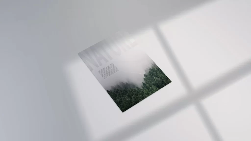 Minimalist free A4 flyer mockup lying flat on a light grey surface with natural window shadow overlays in 8K resolution.